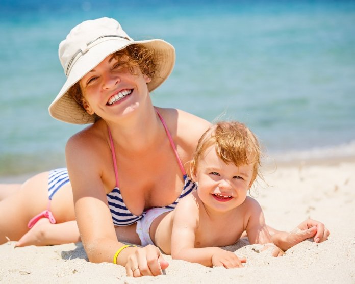 Mother with little daughter on the beach